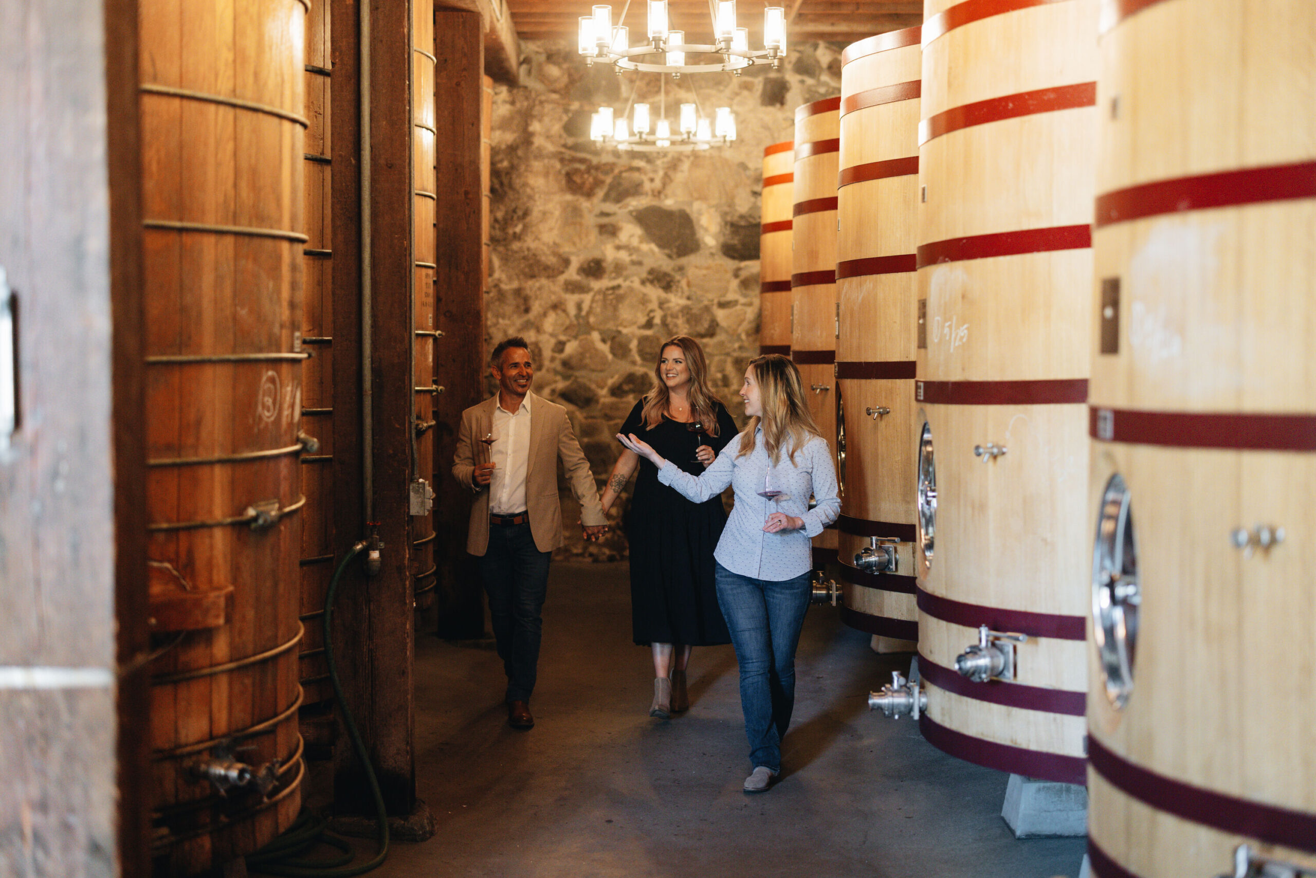 A couple taking a tour of the cellar at Heitz Cellar with Director of Winemaking, Brittany Sherwood.