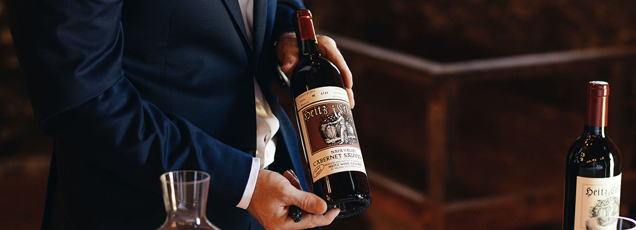 A Heitz Cellar wine educator holding a bottle of Heitz Cellar Cabernet Sauvignon